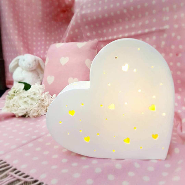 heart shaped kids lamp in white with heart shaped piercings